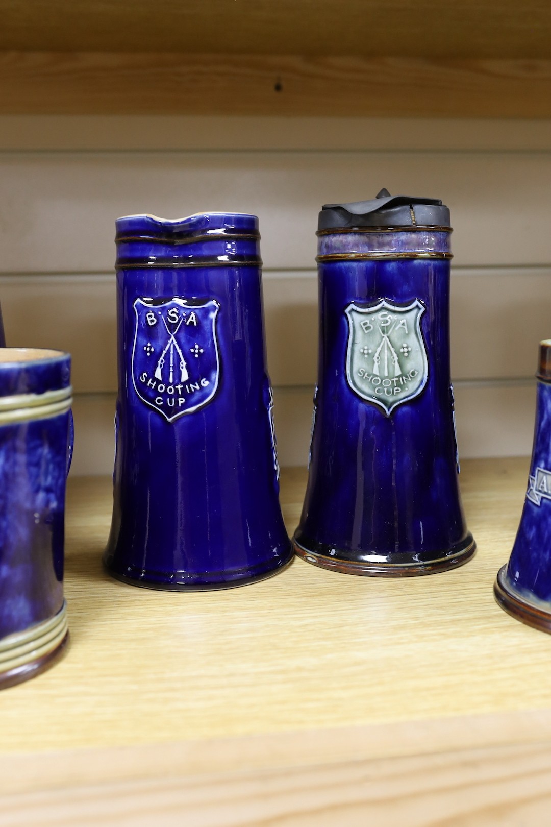 Four large Royal Doulton BSA Shooting Club jugs, 20cm, and two related mugs